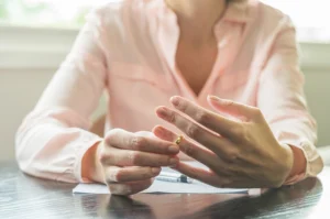 Woman taking off wedding ring